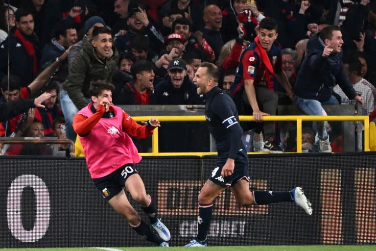After ripping off his shirt, Domenico Criscito, right, raced to the Genoa bench to celebrate his penalty winner (AFP/Marco BERTORELLO)