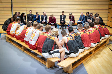 German Chancellor Angela Merkel meets with a local basketball team in Chemnitz, Germany November 16, 2018. Bundesregierung/Guido Bergmann/Handout via REUTERS