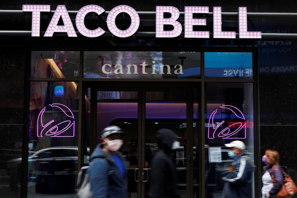 People walk by Taco Bell's first digital-only U.S. cantina location at Times Square in New York City, U.S., April 14, 2021. REUTERS/Shannon Stapleton