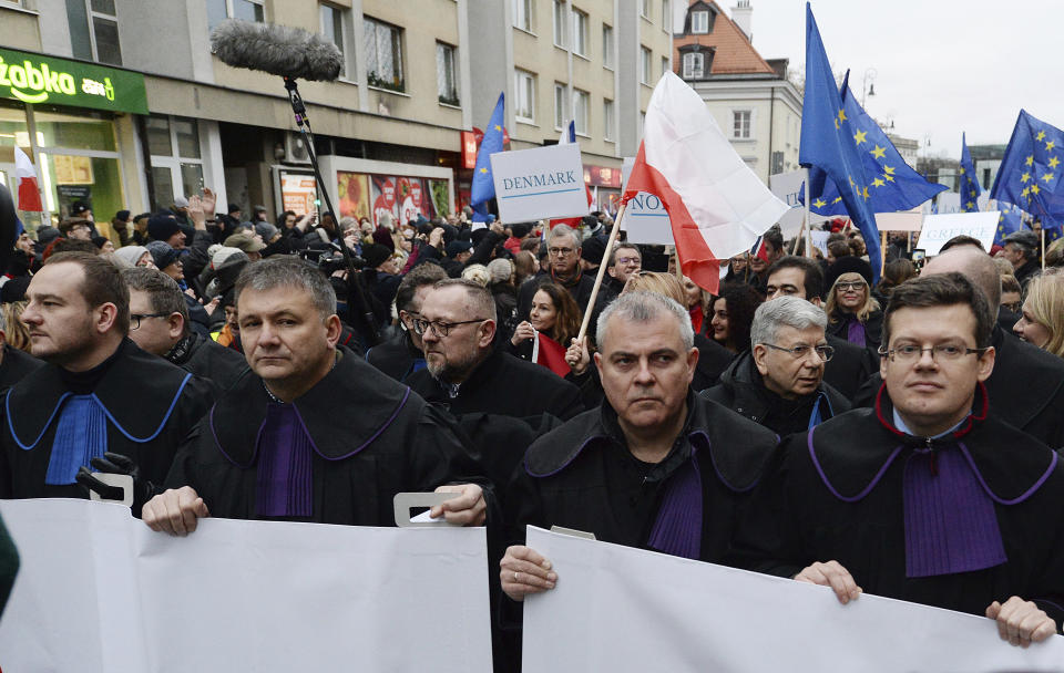 Judges and lawyers from across Europe, many of them dressed in their judicial robes, march silently in Warsaw, Poland, Saturday, Jan. 11, 2020. The rally was a show of solidarity with Polish judges, who are protesting a bill that would allow the government to fire judges whose rulings they don't like. The legislation has been denounced by the European Union and the United Nations. (AP Photo/Czarek Sokolowski)