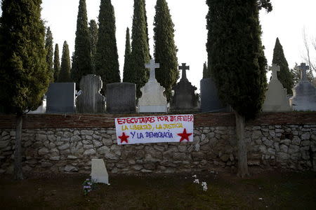 A banner that reads "Executed for defending freedom, justice and democracy" is seen during the exhumation of a grave at Guadalajara's cemetery, Spain, January 19, 2016. REUTERS/Juan Medina