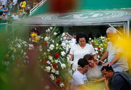 Relatives of players of Brazil's Chapecoense soccer team react before a ceremony mourning the victims after the plane carrying the team crashed in Colombia, at Arena Conda stadium in Chapeco, Brazil, December 2, 2016. REUTERS/Ricardo Moraes