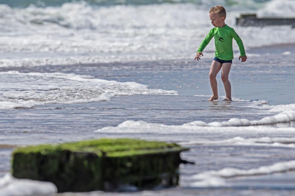 A young visitor dips his feet in the ocean at Rehoboth Beach on Saturday, May 27, 2023. Rip currents restricted swimmers to knee-deep entry into the ocean in selected areas of the beach.