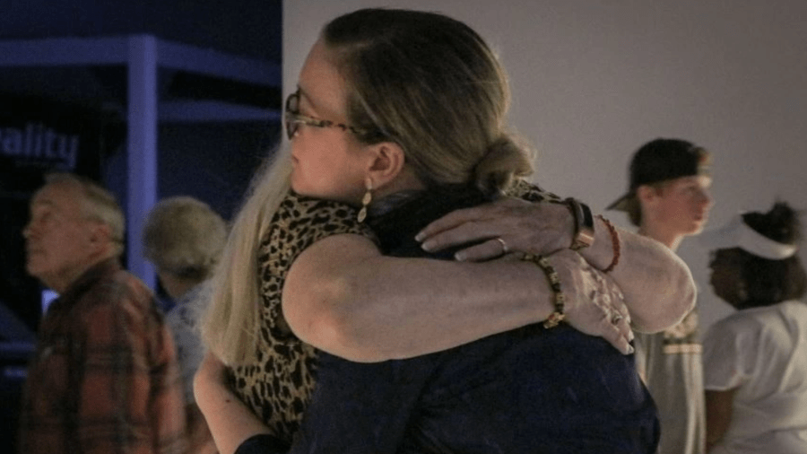 Dr. Dawn Alexandrea Berry embraces a family member of a soldier lost in the Korean War or Cold War at a tour of the National Museum. (DPAA)