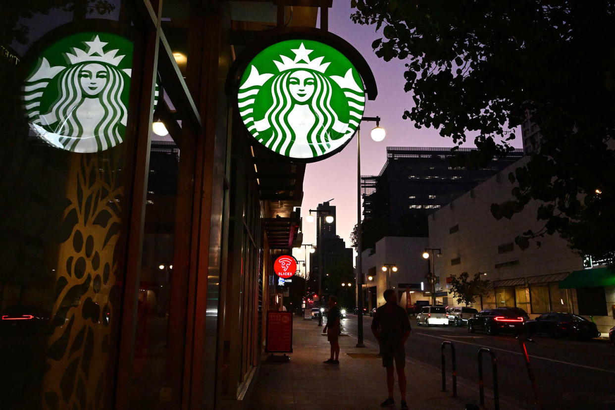 starbucks sign pedestrian dusk (Frederic J. Brown / AFP via Getty Images file)