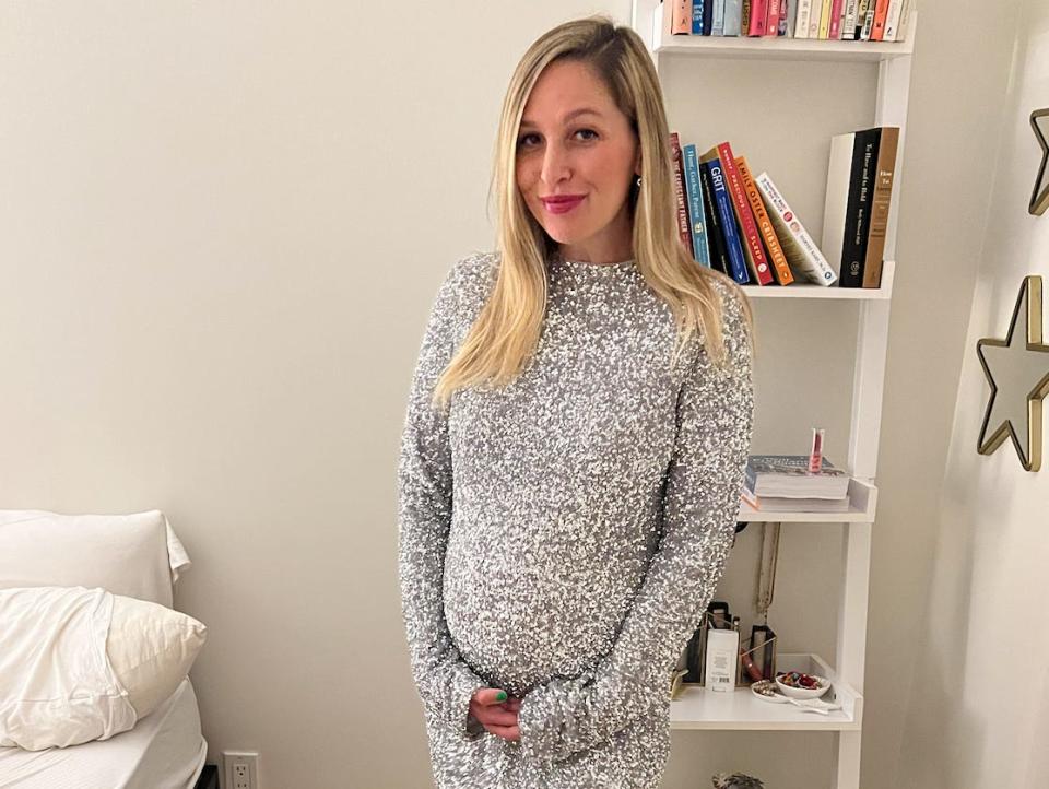 The author posing with one of the dresses she bought.