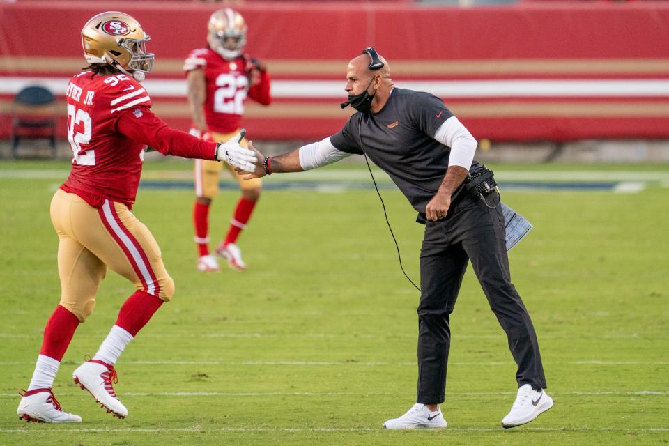 San Francisco 49ers defensive coordinator Robert Saleh high-fives defensive end Kerry Hyder during the game against the Philadelphia Eagles at Levi's Stadium, Oct. 4, 2020.
