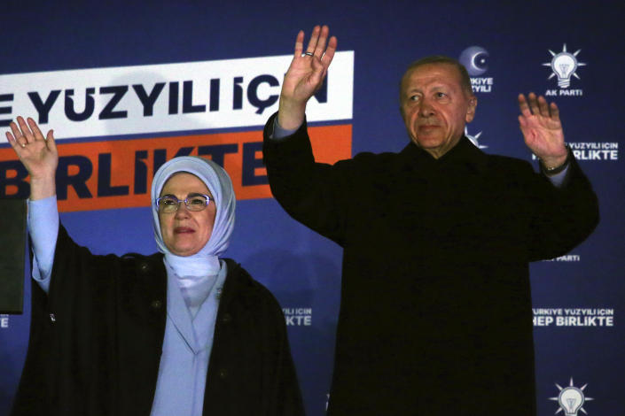 Turkish President Recep Tayyip Erdogan, right, and his wife Emine gesture to supporters at the party headquarters, in Ankara, Turkey, early Monday, May 15, 2023. Erdogan, who has ruled his country with an increasingly firm grip for 20 years, was locked in a tight election race Sunday, with a make-or-break runoff against his chief challenger possible as the final votes were counted. (AP Photo/Ali Unal)