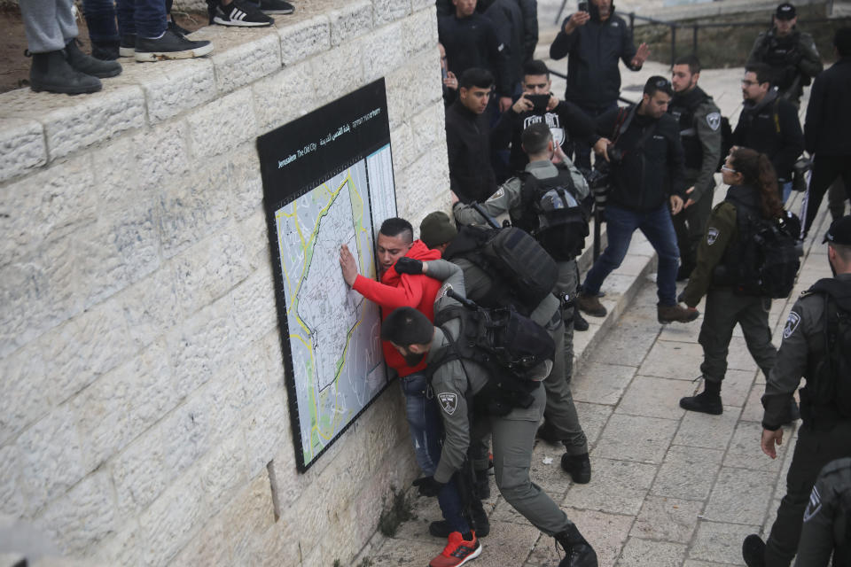 Israeli border police frisks a Palestinian ahead of a protest against Middle East peace plan announced Tuesday by US President Donald Trump, which strongly favors Israel, in Jerusalem, Wednesday, Jan 29, 2020. (AP Photo/Mahmoud Illean)