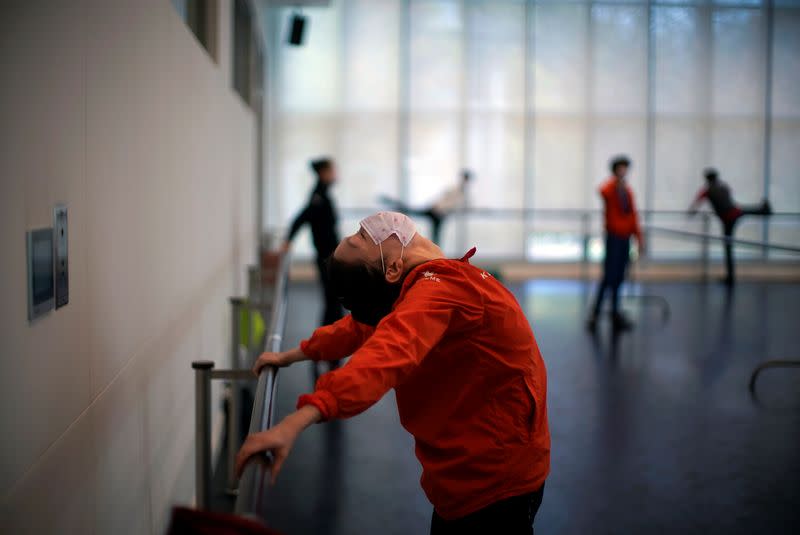 Shanghai Ballet dancers wearing masks practise in a dance studio in Shanghai