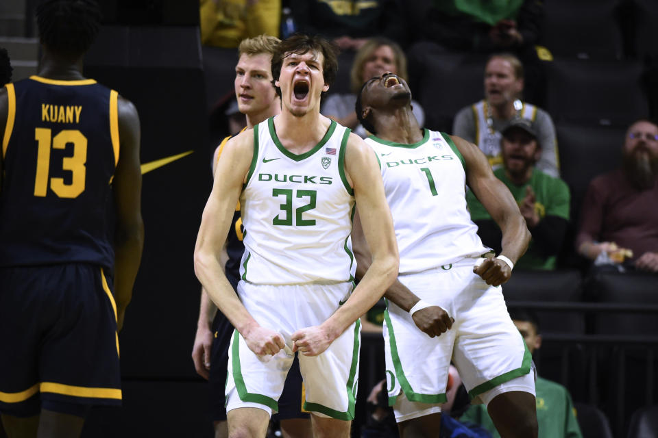 Oregon center Nate Bittle (32) celebrates with center N'Faly Dante (1) after Bittle was fouled on a layup, while California forward Lars Thiemann, left, walks past during the second half of an NCAA college basketball game Thursday, March 2, 2023, in Eugene, Ore. (AP Photo/Andy Nelson)