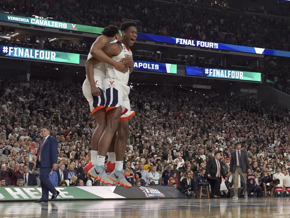 Virginia's De'Andre Hunter, right, and Braxton Key celebrate after defeating Auburn 63-62 in the semifinals of the Final Four NCAA college basketball tournament, Saturday, April 6, 2019, in Minneapolis. (AP Photo/David J. Phillip)