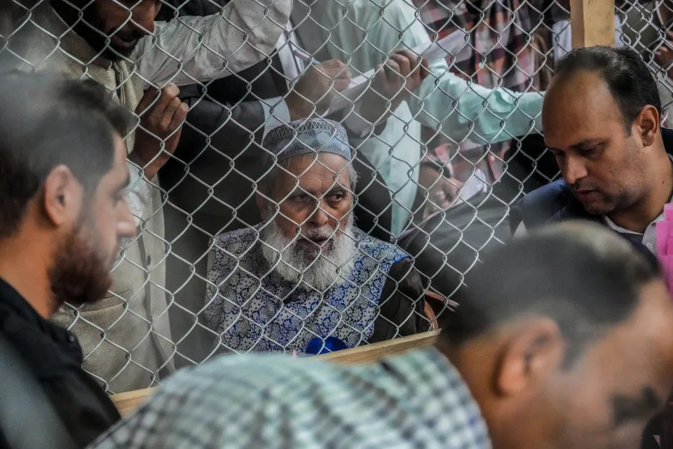 Political party representatives watch as polling officials count the votes in the recent election for a local government in Indian-controlled Kashmir on the outskirts of Srinagar, Tuesday, Oct. 8, 2024. (AP Photo/Mukhtar Khan)