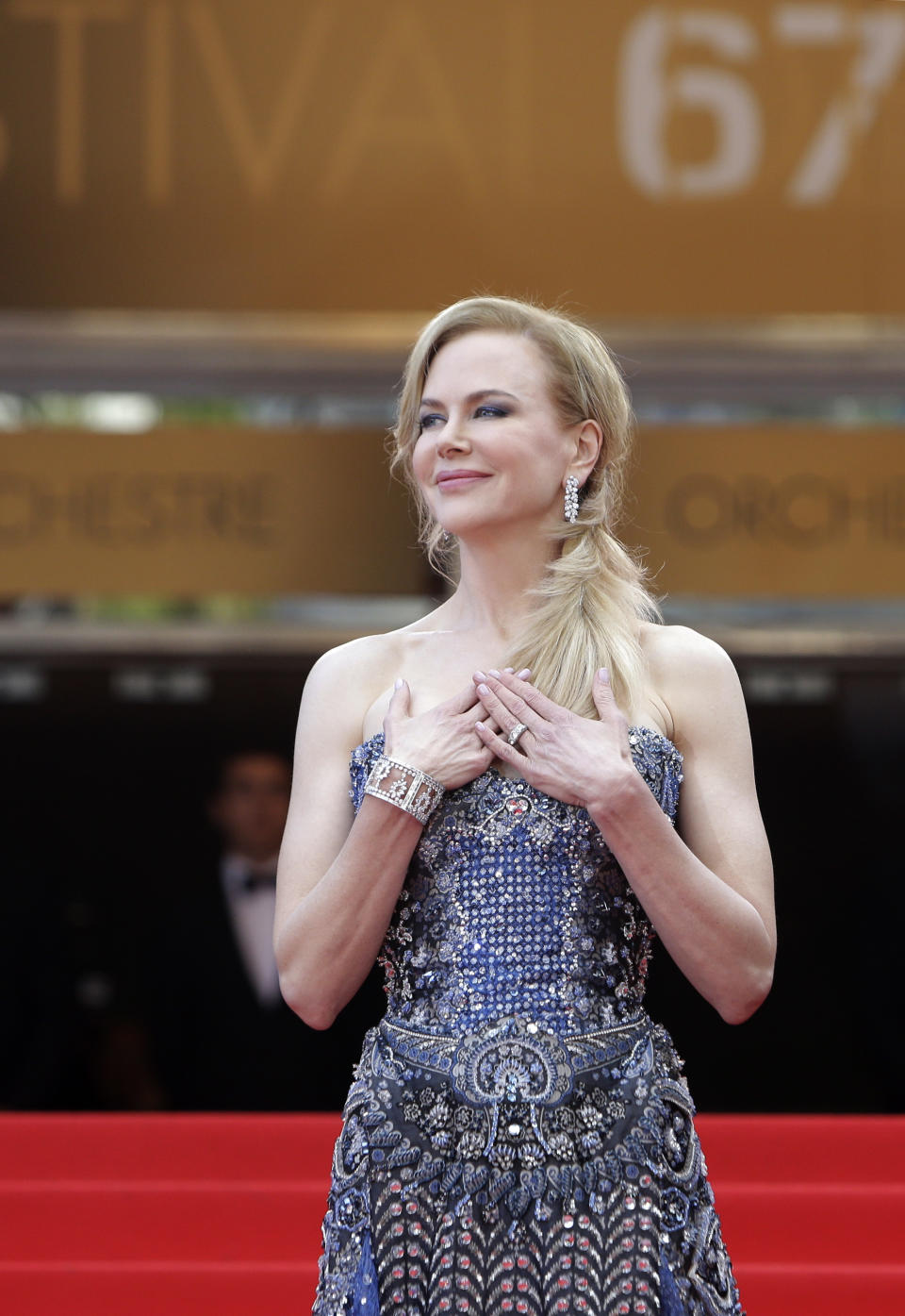 Actress Nicole Kidman stands at the top of the red carpet as she arrives for the opening ceremony and screening of Grace of Monaco at the 67th international film festival, Cannes, southern France, Wednesday, May 14, 2014. (AP Photo/Thibault Camus)