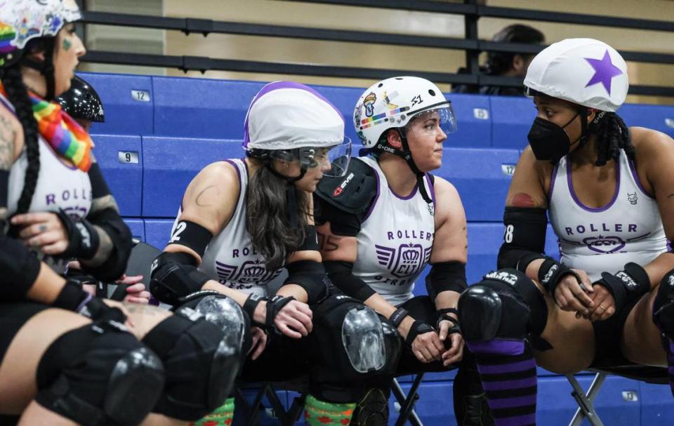 Charlotte Roller Derby players talk on the bench before the next jam against Collision in Charlotte, N.C., on Saturday, March 11, 2023.