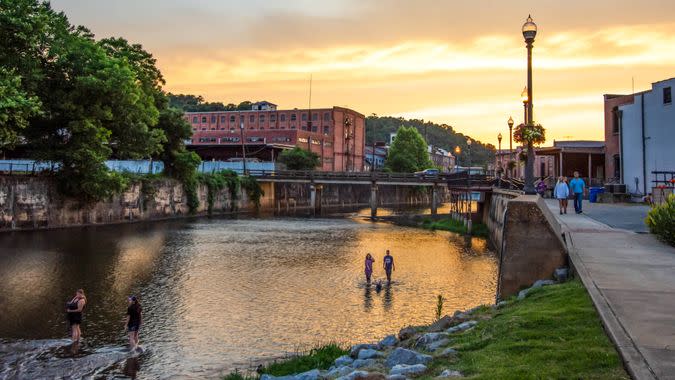 Prattville, Alabama/USA-June 12, 2019: A scenic view of people enjoying Autauga Creek and the Creekwalk area of Prattville during a beautiful golden sunset on a warm summer evening.