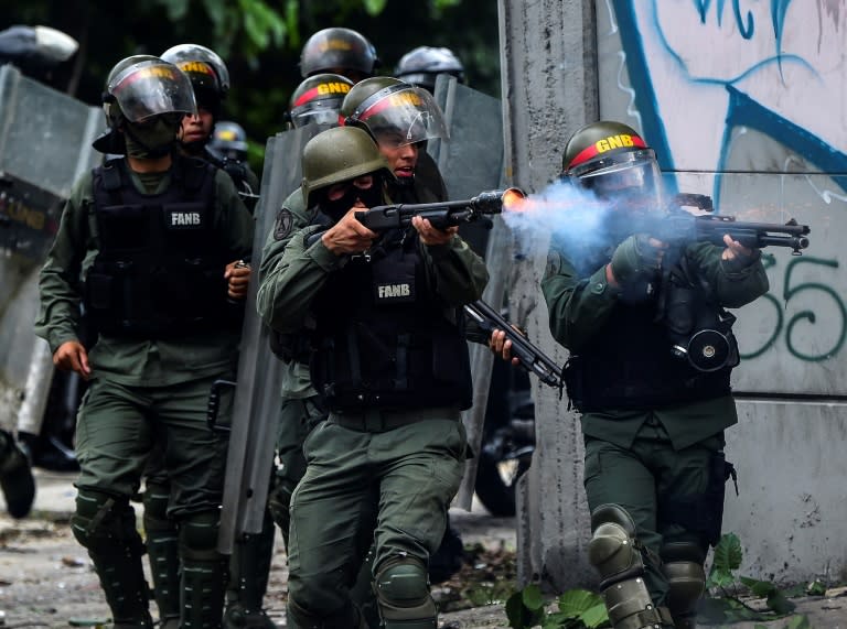 National Guard officers clash with opposition activists during a march towards the Supreme Court of Justice in Caracas