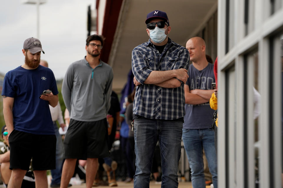 People who lost their jobs wait in line to file for unemployment following an outbreak of the coronavirus disease (COVID-19), at an Arkansas Workforce Center in Fayetteville, Arkansas, U.S. April 6, 2020. REUTERS/Nick Oxford