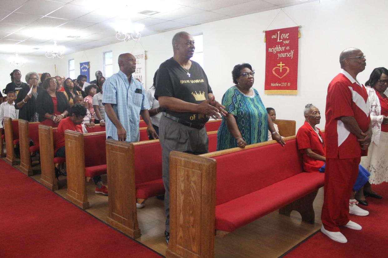 Descendants of victims of the Rosewood Massacre stand to praise the Lord during a worship service at Mount Olive AME Church in SE Gainesville to end their family on Sunday. This past January marked the centennial anniversary of the massacre in the small town in Levy County located less than an hour away from Gainesville.
(Credit: Photo by Voleer Thomas/For The Guardian)