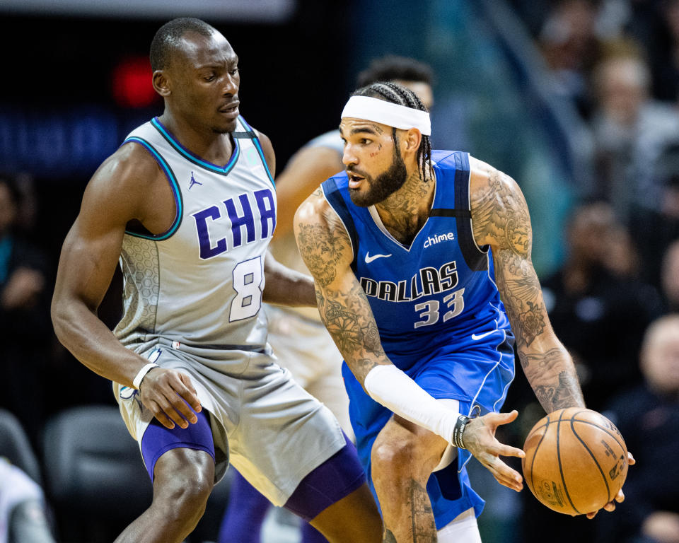 Bismack Biyombo #8 of the Charlotte Hornets defends against Willie Cauley-Stein #33 of the Dallas Mavericks.