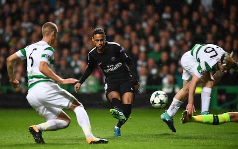 Paris Saint-Germain's Brazilian striker Neymar (C) shoots to score the opening goal of the UEFA Champions League Group B football match between Celtic and Paris Saint-Germain  - Credit: AFP