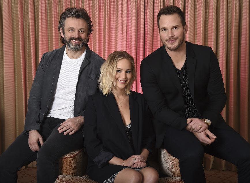 This Dec. 9, 2016 file photo shows, from left, Michael Sheen, Jennifer Lawrence and Chris Pratt during a portrait session for their upcoming movie "Passengers" in Los Angeles. (Photo by Jordan Strauss/Invision/AP)