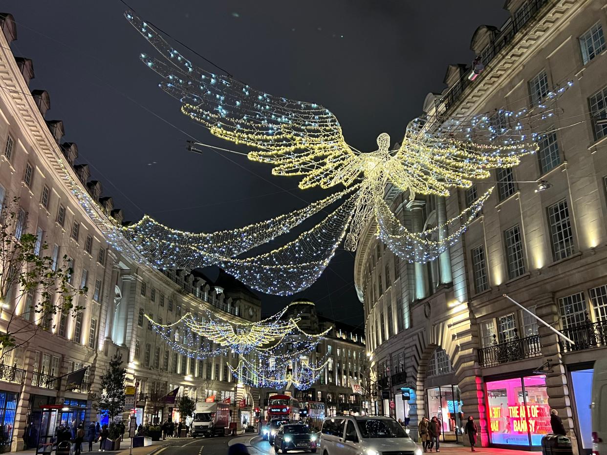 Lighted angels glitter above Regent Street, a high-end shopping district in London.