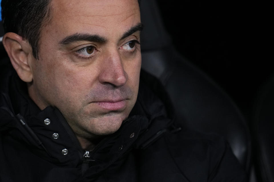 Barcelona's head coach Xavi Hernandez looks out from the bench before the Spanish Copa del Rey semi final, first leg soccer match between Real Madrid and Barcelona at Santiago Bernabeu stadium in Madrid, Spain, Thursday, March 2, 2023. (AP Photo/Manu Fernandez)