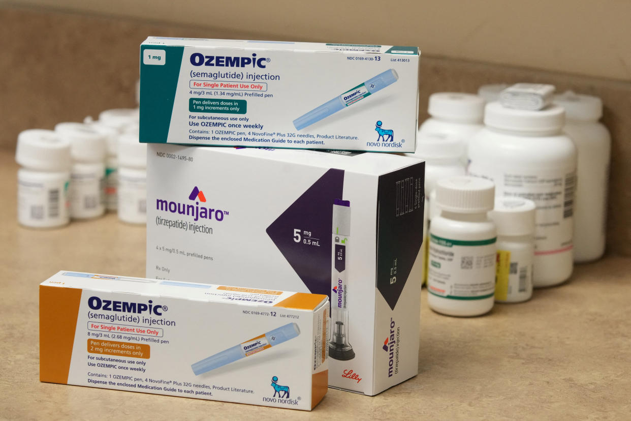 Boxes of weight loss and diabetes drugs are shown on a table at a pharmacy.