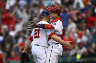 Washington Nationals catcher Riley Adams, right, and relief pitcher Tanner Rainey (21) celebrate after the team's baseball game against the Los Angeles Dodgers, Wednesday, May 25, 2022, in Washington. The Nationals won 1-0. (AP Photo/Nick Wass)