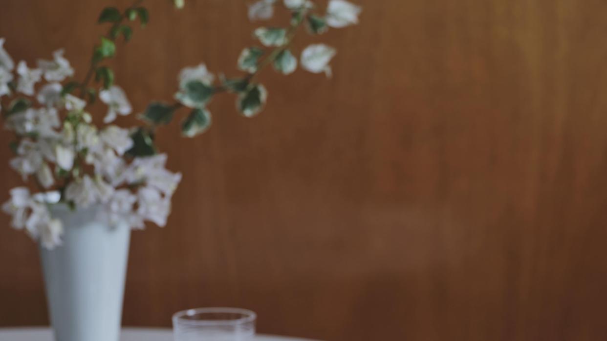 a vase with white flowers on a table