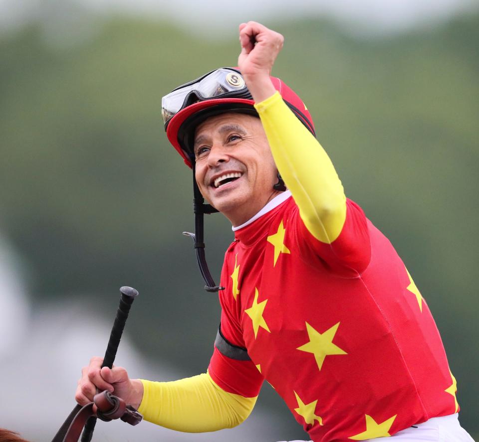 Jockey Mike Smith celebrates aboard Justify after capturing the Triple Crown after winning the Belmont Stakes June 9, 2018 at Belmont Park in Elmont, NY.