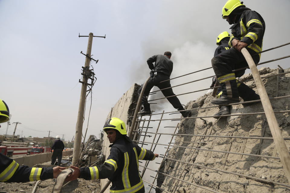 Afghan firefighters work at the site of Monday's suicide bomb attack in Kabul, Afghanistan, Tuesday, Sept. 3, 2019. The attack occurred late Monday near the the Green Village, home to several international organizations and guesthouses. (AP Photo/Rahmat Gul)