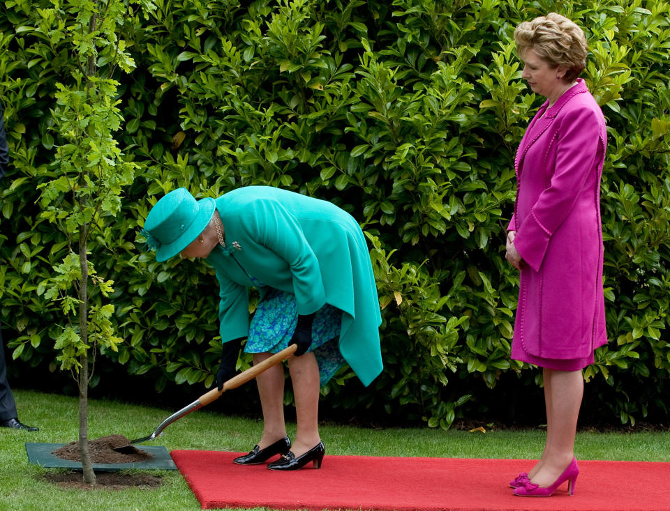 <p>The Queen plants a tree in the grounds of Áras An Uachtaráin in Dublin as Irish president Mary McAleese looks on at the start of a historic visit to Ireland on 17 May 2011. It was the first visit by a British monarch since 1911. (PA)</p> 
