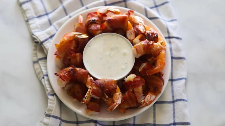 Shrimp-wrapped bacon on plate