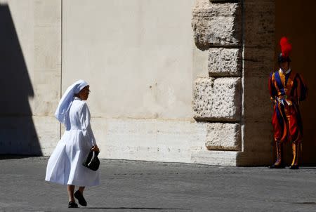 A nun walks past the courtyard prior to the French President Emmanuel Macron's arrival for the meeting with Pope Francis at the Vatican, June 26, 2018. REUTERS/Stefano Rellandini