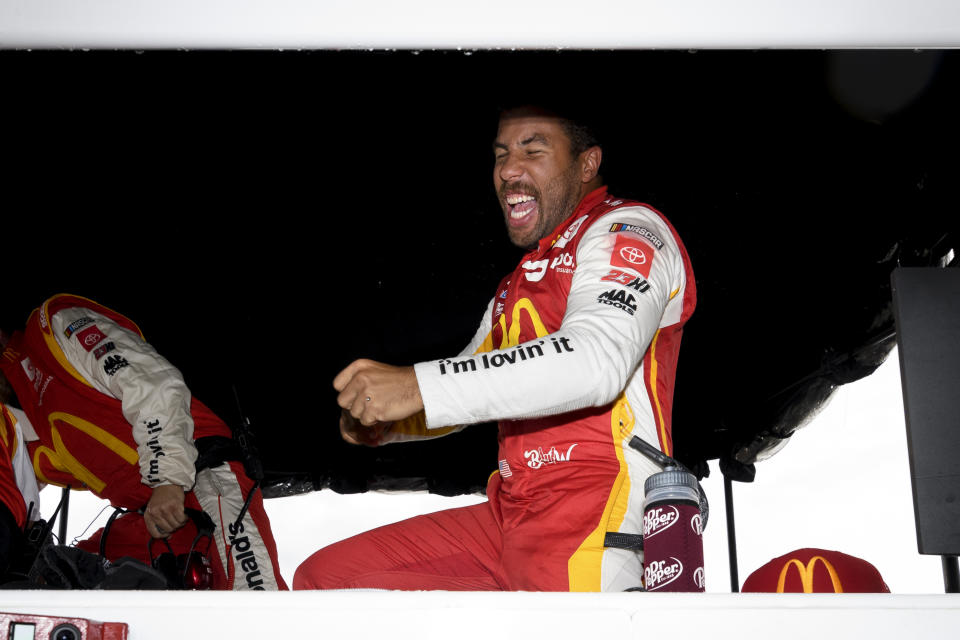 Bubba Wallace reacts after he is pronounced the winner while waiting out a rain delay before which he was the leader during a NASCAR Cup series auto race Monday, Oct. 4, 2021, in Talladega, Ala. (AP Photo/John Amis)