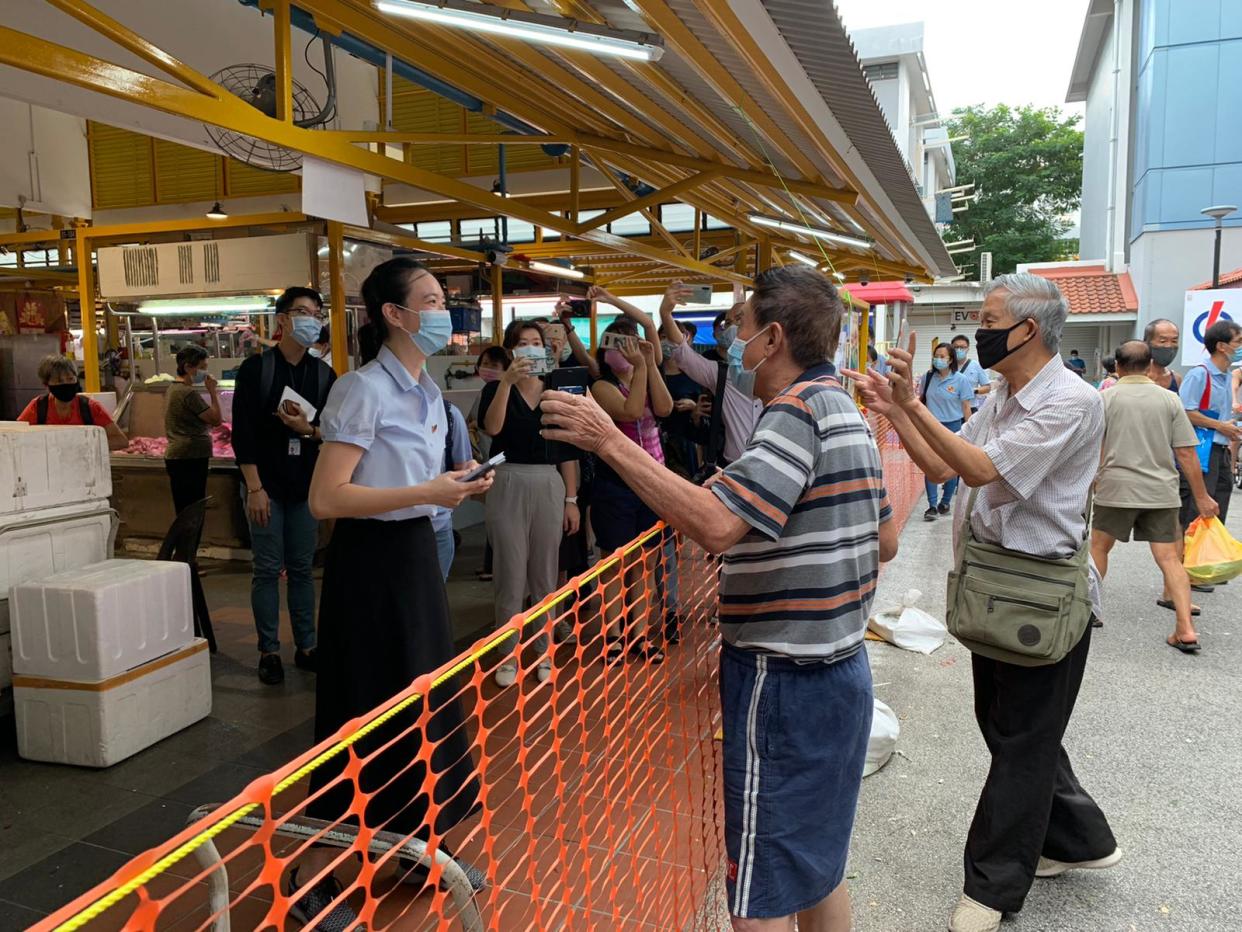 Workers' Party candidate for East Coast GRC Nicole Seah speaking to residents at Bedok North on Wednesday morning (1 July).