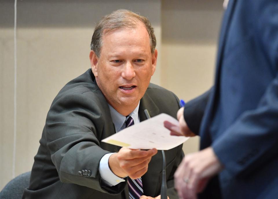 Chief Assistant State Attorney Craig Schaeffer is handed a document while he testifies in court on Tuesday. The Herald-Tribune sought to overturn an emergency injunction barring the news organization from publishing the names of two deputies involved in a fatal shooting.