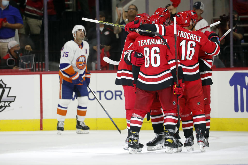 The Carolina Hurricanes celebrates a goal by Teuvo Teravainen (86) against the New York Islanders during the third period of an NHL hockey game in Raleigh, N.C., Thursday, Oct. 14, 2021. (AP Photo/Karl B DeBlaker)