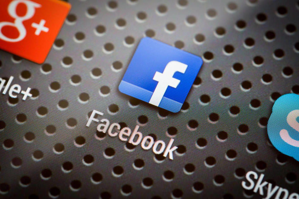 BELCHATOW, POLAND - APRIL 10, 2014: Closeup photo of Facebook icon on mobile phone screen. Popular social network.