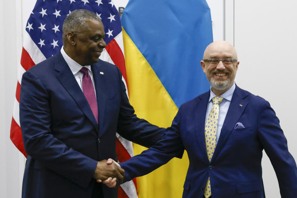 U.S. Defense Secretary Lloyd Austin, left, shakes hands with Ukraine's Defense Minister Oleksii Reznikov ahead of a NATO defence ministers' meeting at NATO headquarters in Brussels, Wednesday, June 15, 2022. NATO defense ministers, attending a two-day meeting starting Wednesday, will discuss beefing up weapons supplies to Ukraine, and Sweden and Finland's applications to join the transatlantic military alliance. (Yves Herman, Pool Photo via AP)