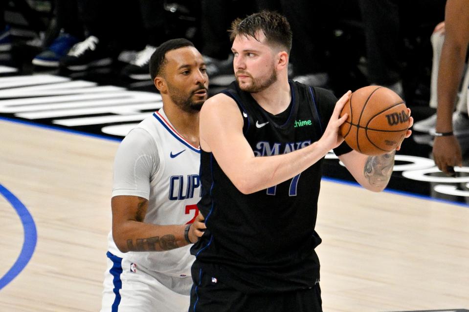 Dallas Mavericks guard Luka Doncic (77) looks to move the ball past LA Clippers guard Norman Powell (24) during the fourth quarter during game six of the first round for the 2024 NBA playoffs at American Airlines Center.