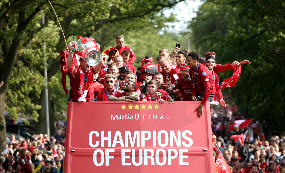 Liverpool's James Milner (left) with the trophy on an open top bus during the Champions League Winners Parade in Liverpool.