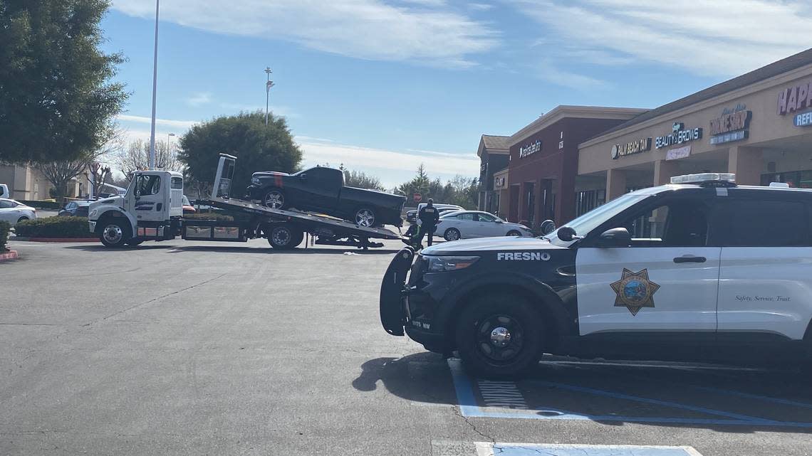 A truck is towed from the shooting at a shopping center in Fresno, California on Monday, Feb. 20 2023.