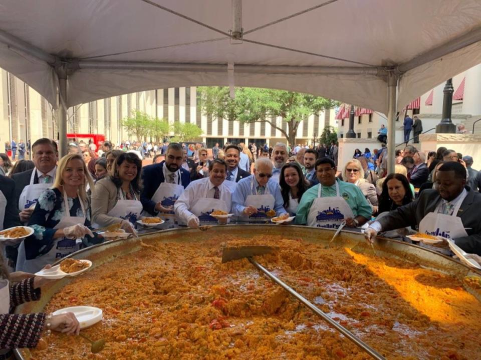 The annual “Paella Fest” will be a feature of the annual Miami-Dade County days, set for Feb. 5-6 this year. In this photo from 2019, legislators, lobbyists and Miami-Dade officials serve up the massive rice dish in the plaza of the state Capitol. 