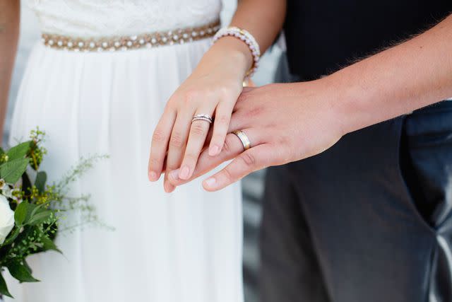 <p>Getty</p> Newlywed couple showing their wedding rings