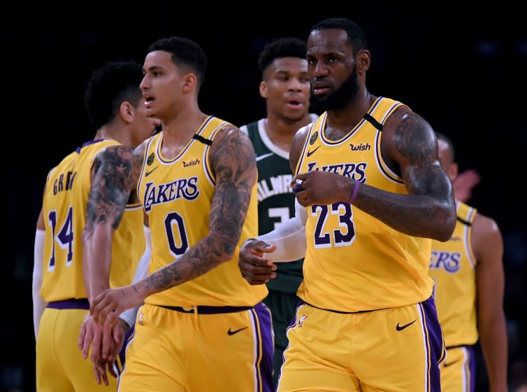 LOS ANGELES, CALIFORNIA - MARCH 06: LeBron James #23 and Kyle Kuzma #0 of the Los Angeles Lakers react after a James score, in front of Giannis Antetokounmpo #34 of the Milwaukee Bucks during a 113-103 Laker win at Staples Center on March 06, 2020 in Los Angeles, California. NOTE TO USER: User expressly acknowledges and agrees that, by downloading and or using this photograph, User is consenting to the terms and conditions of the Getty Images License Agreement. (Photo by Harry How/Getty Images)