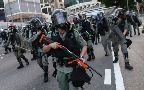 Armed Riot police officers on patrol during an anti-government rally  - Credit: JEROME FAVRE/EPA-EFE/REX