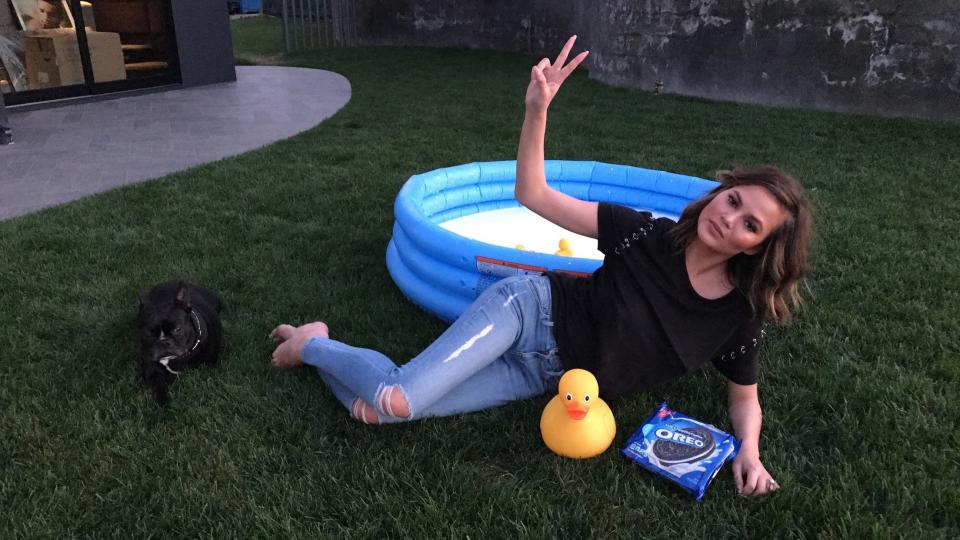 Chrissy Teigen strikes a pose after doing the OREO Dunk Challenge.&nbsp;